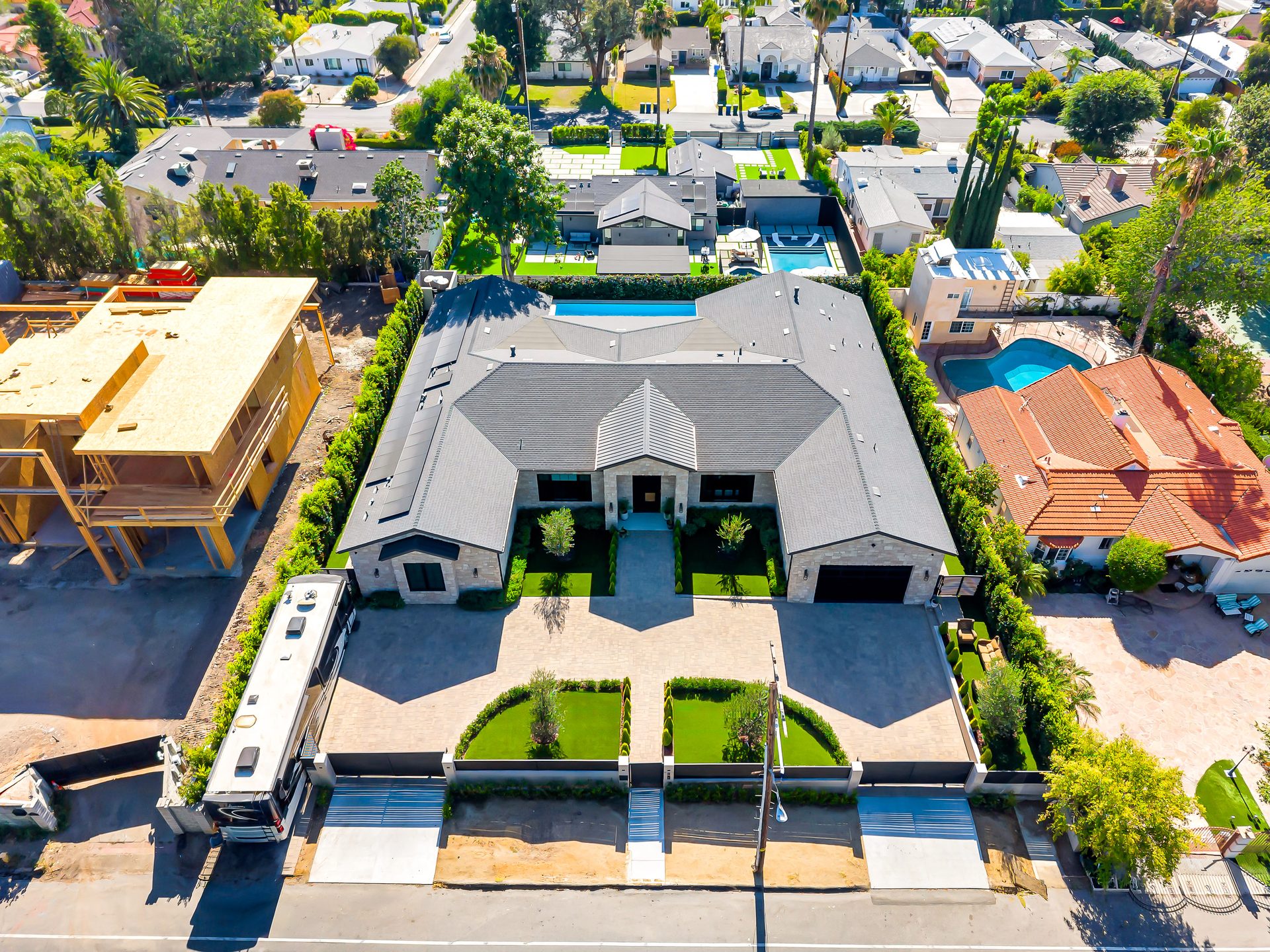 Aerial view of a completed Pacific Green Homes estate with pool and landscaped grounds