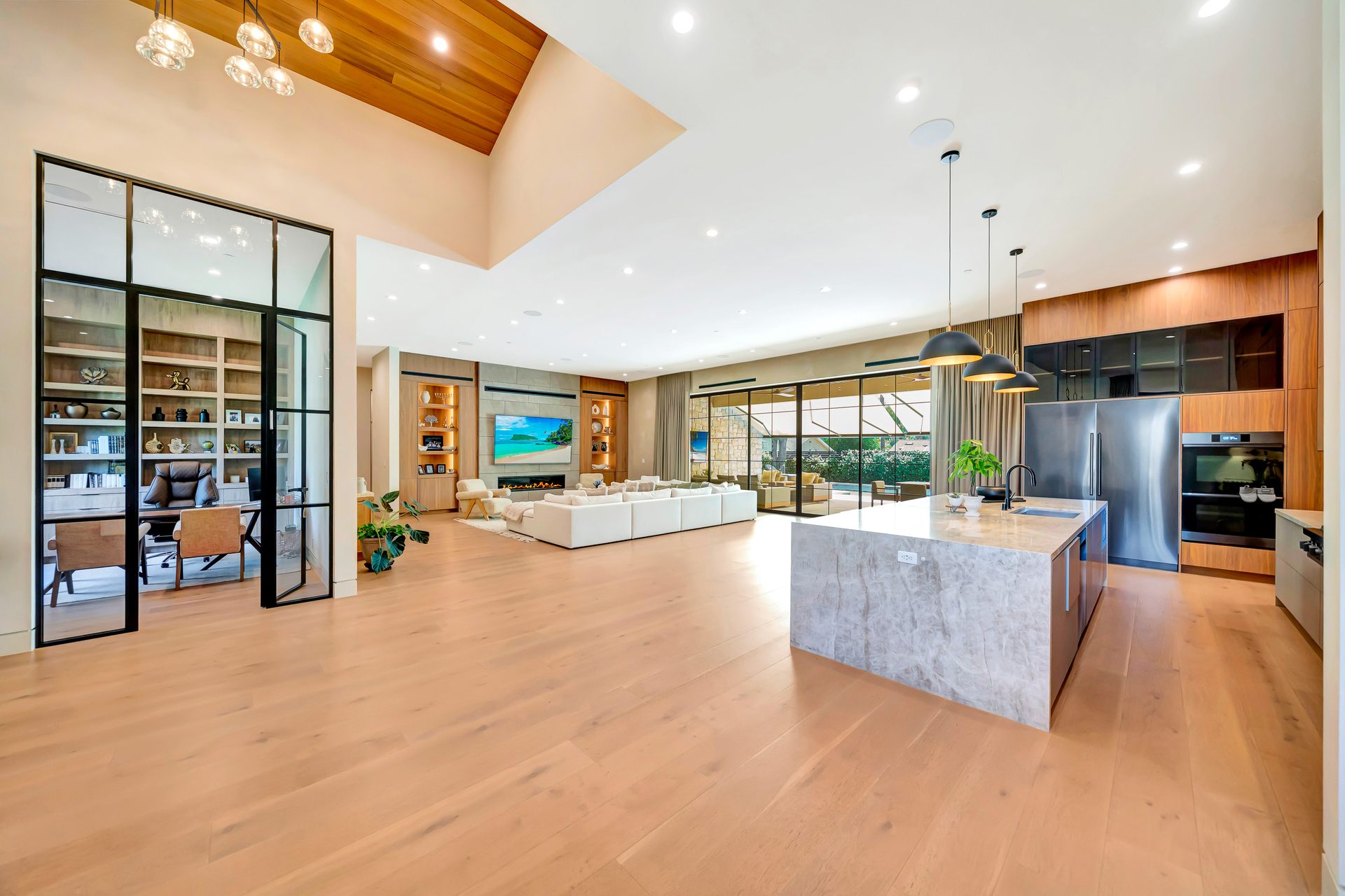 Great room with vaulted ceiling and walls of glass