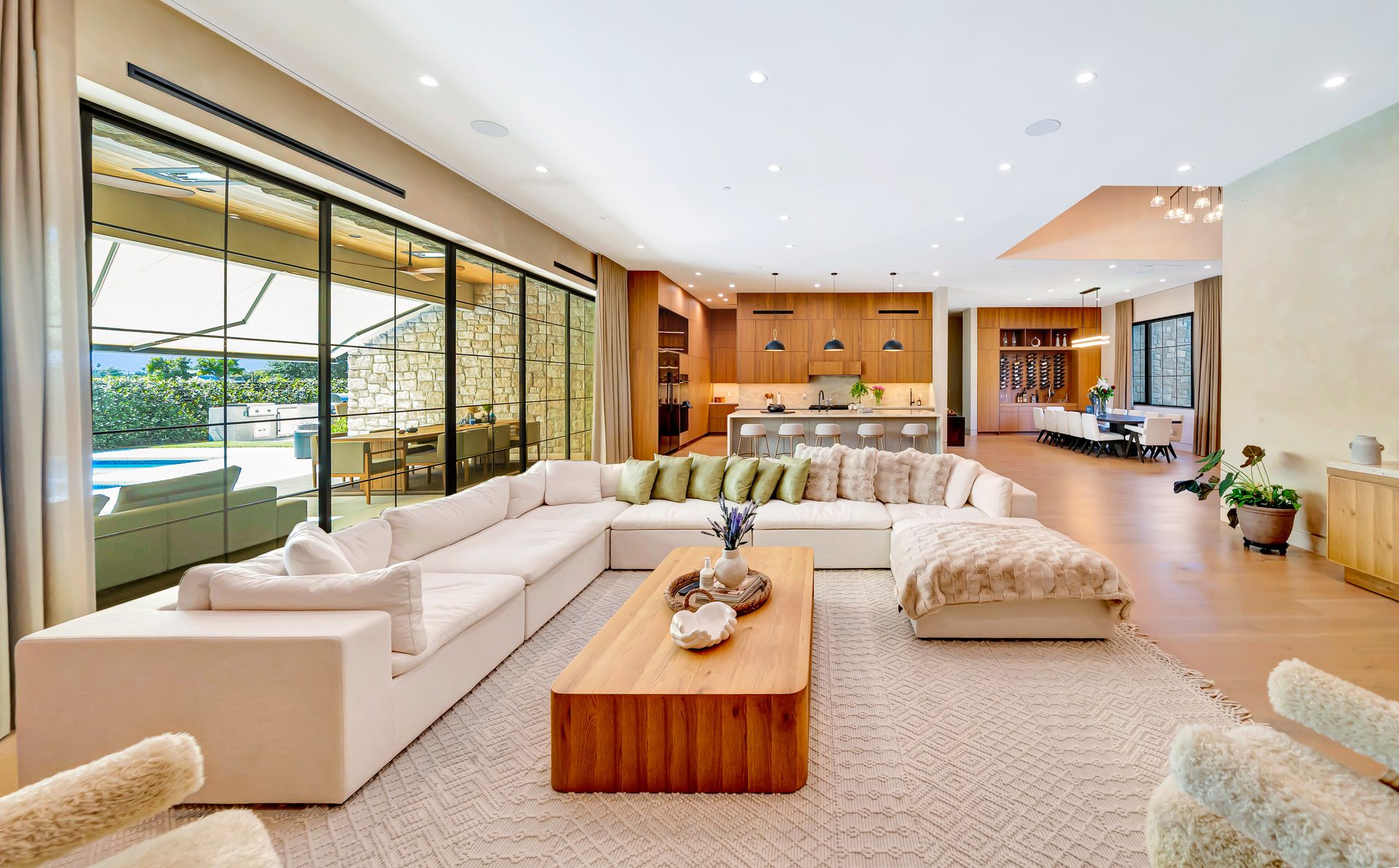 Open plan living room with floor to ceiling glass