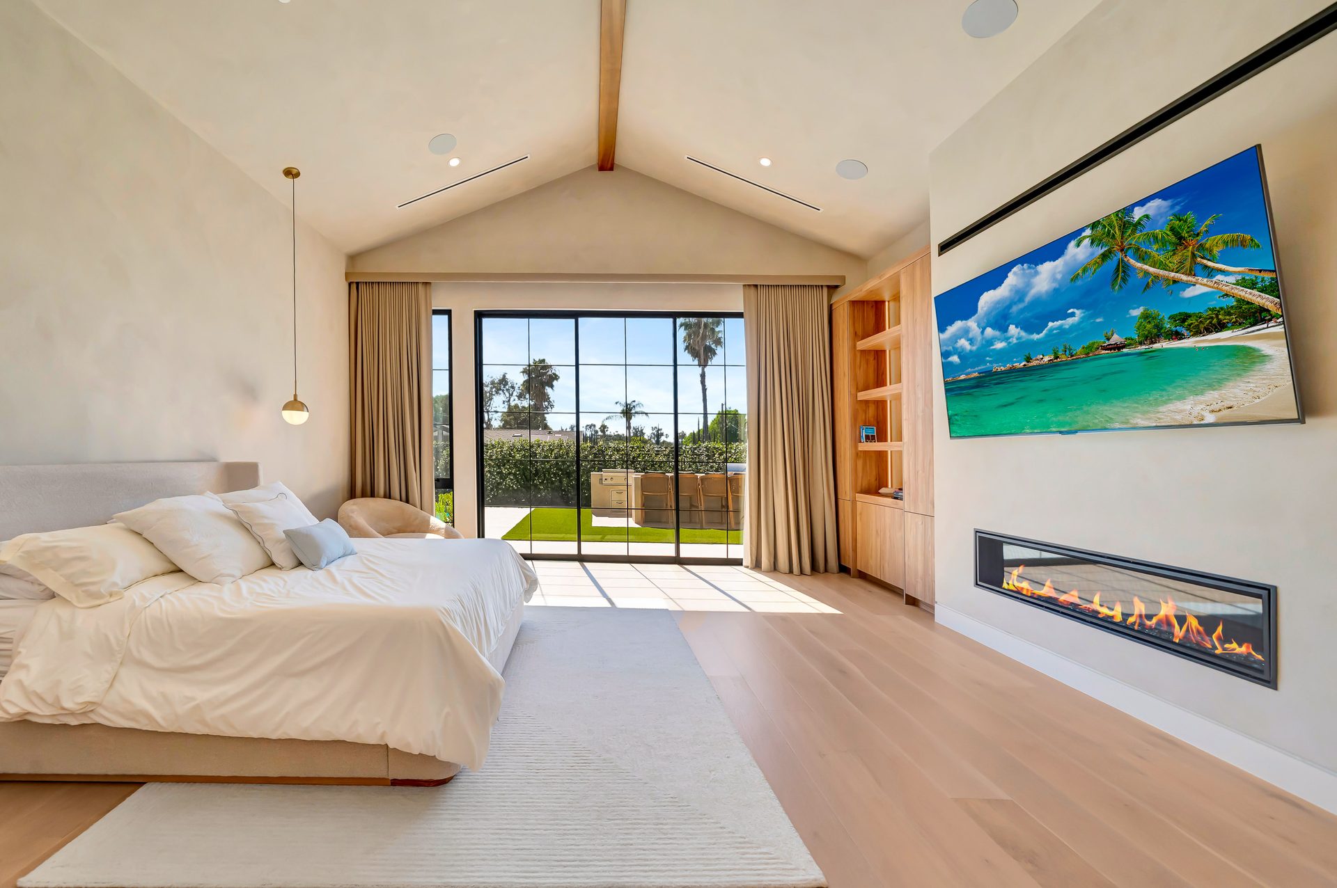 Primary bedroom with fireplace and floor to ceiling windows