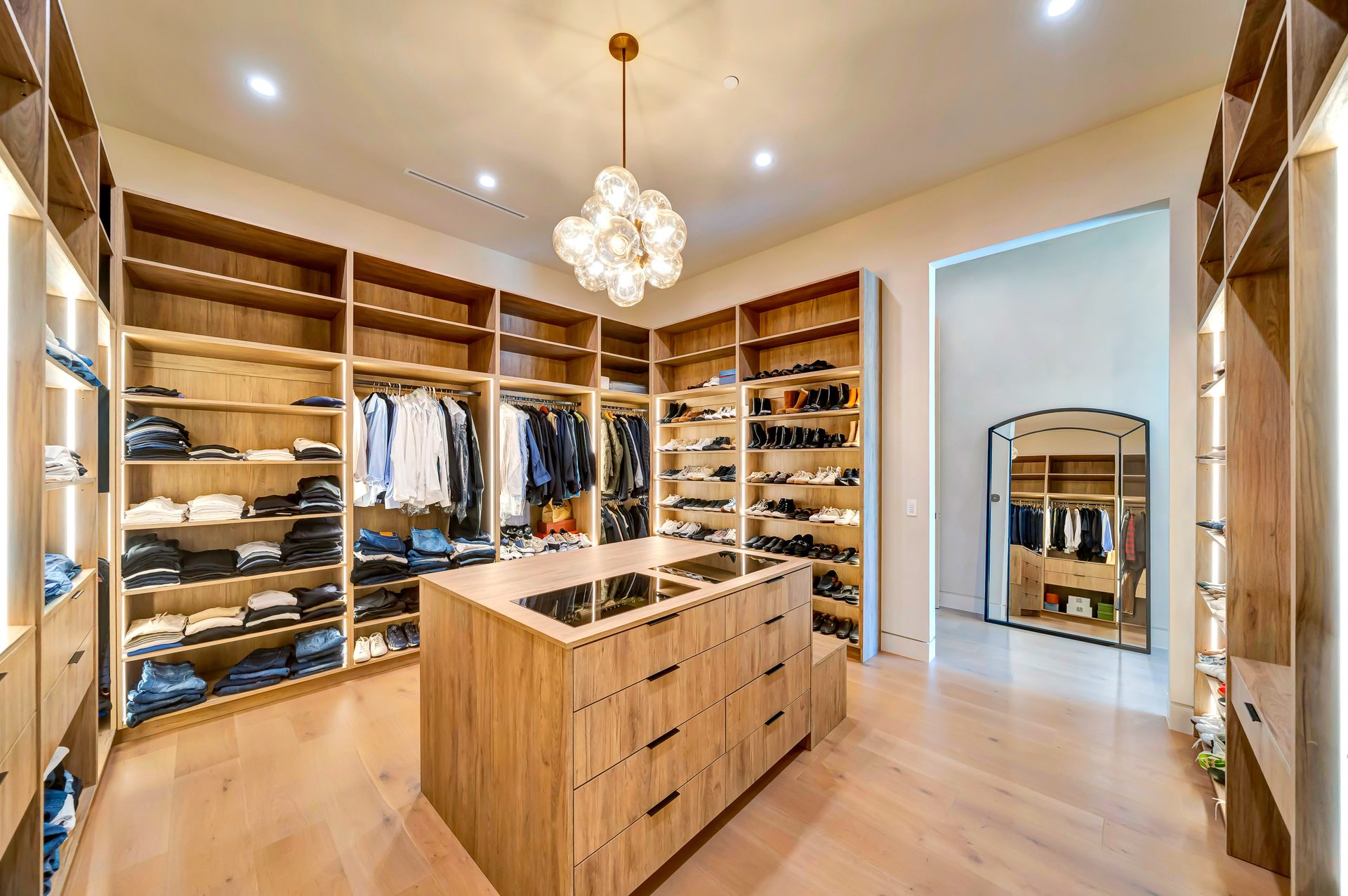 Custom walk in closet with island and built in storage